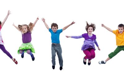 Happy kids jumping high - isolated