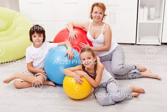 Happy woman and kids exercising at home