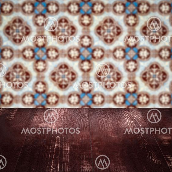 Wood table top and blur vintage ceramic tile pattern wall