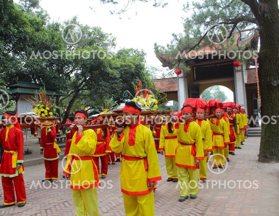 Group of people in traditional costume give gifts to the...