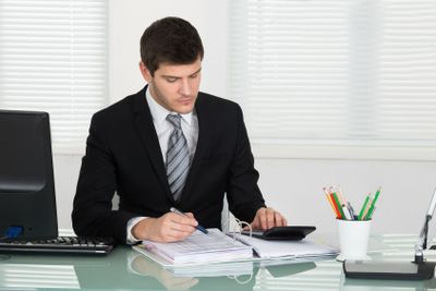 Businessman Calculating Bill