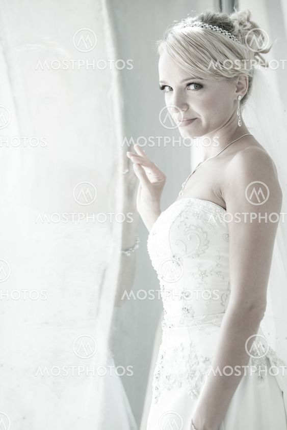 Beautiful blond bride in window