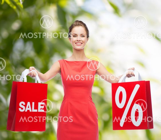 young woman in red dress with shopping bags