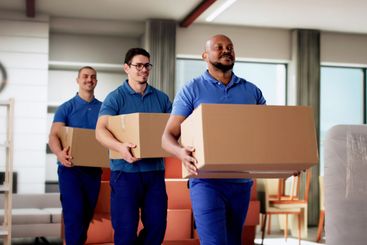 Professional Movers Smiling While Holding Boxes
