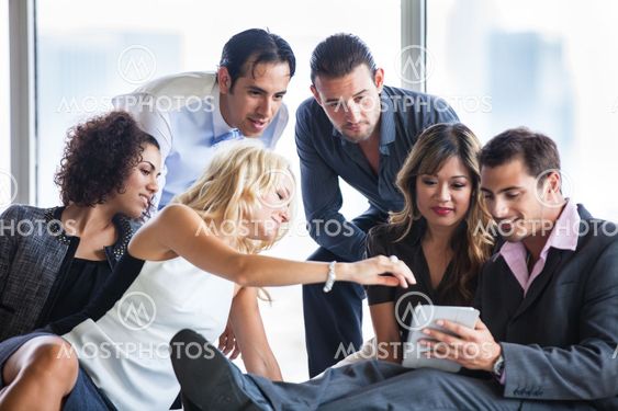 Attractive group of young people collaborating on an idea