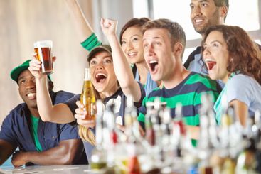 Pub, friends and football game celebration for team...