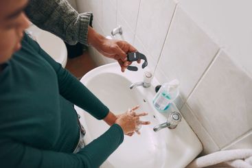 Water, soap and couple washing hands with watch in...