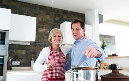 Senior couple in the kitchen cooking together.