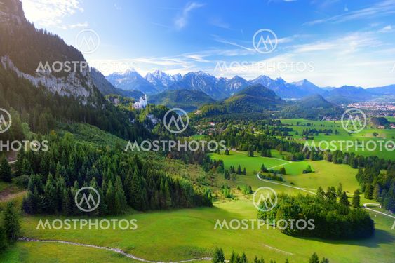 Famous Neuschwanstein Castle visible in the distance,...