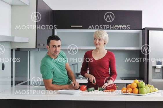 young couple have fun in modern kitchen