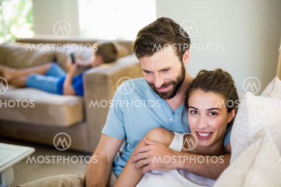 Young couple embracing on sofa