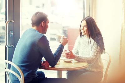 happy couple drinking tea and coffee at cafe