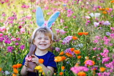 Portriat of adorable, charming toddler girl with Easter...