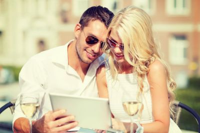 couple looking at tablet pc in cafe