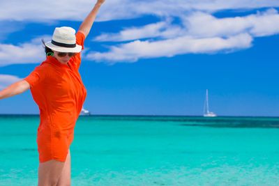 Young girl on seashore during summer vacation