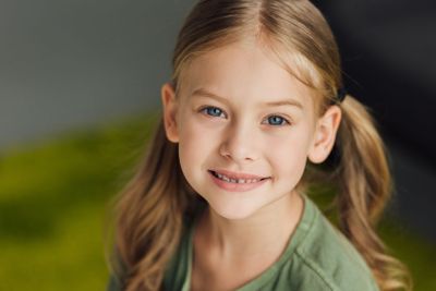 close-up portrait of adorable little child smiling at...