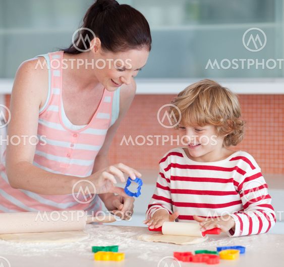 Smiling boy with his mother and cookie cutter