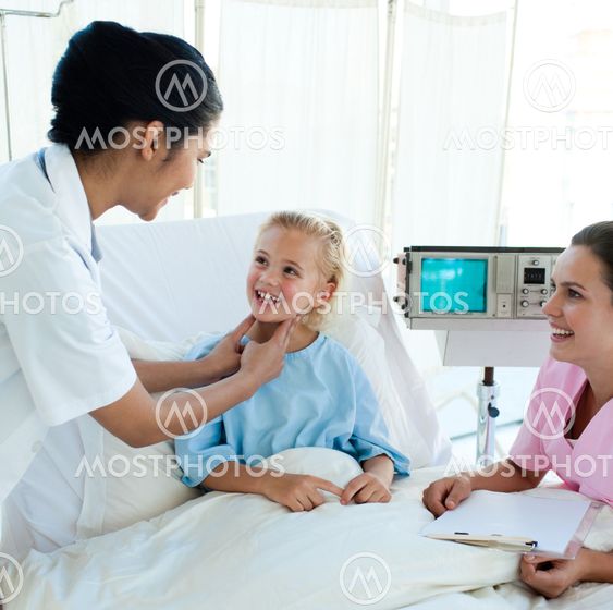 Smiling doctor attending a young patient