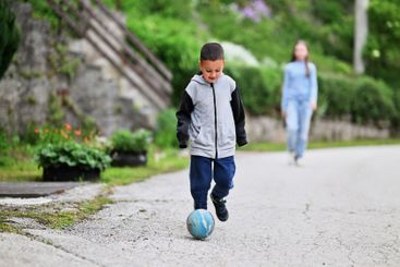 Children playing together in a park or engaging in a game.