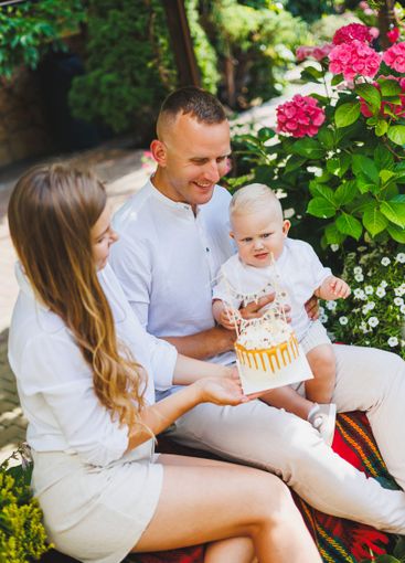 Mom and dad in nature with their one-year-old son...