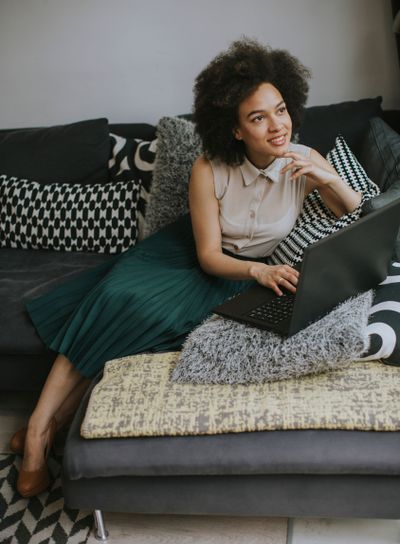 Attractive young woman working on laptop at home
