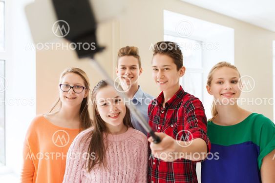 group of students taking selfie with smartphone