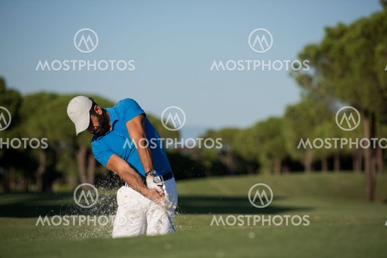 pro golfer hitting a sand bunker shot