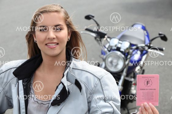 Woman with a motorbike and driver's license