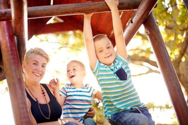 Happy, park and mom with kids for playing, childhood and...