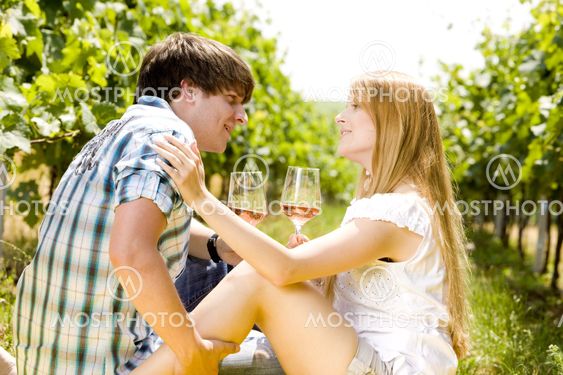 couple at a picnic in vineyard