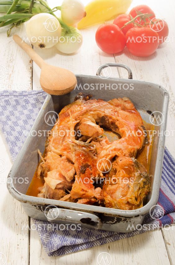 boiled carp in a gray metal cooking tin