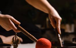 Practicing sound healing with singing bowls during a...