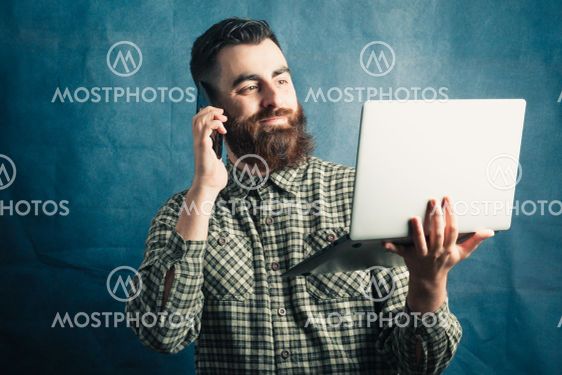 Young hipster man with beard concept working with a...