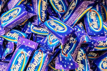 Colorful assortment of Milky Way candy bars in purple...