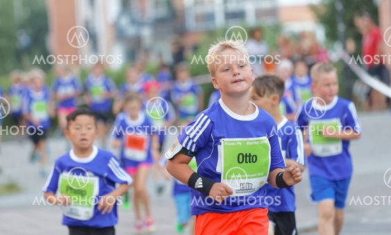 Young blonde boy running