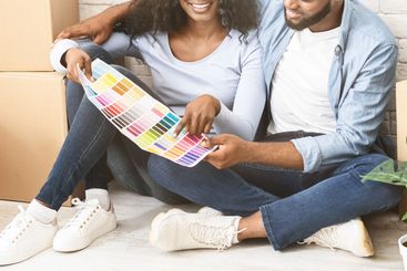 Married black couple choosing walls colour for new...