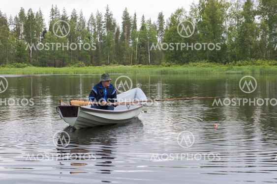 Man sitting in boat fishing