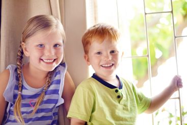 Happy, fun and portrait of children in home for playing,...