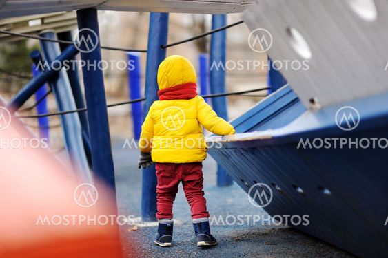 Cute little boy having fun on outdoor playground