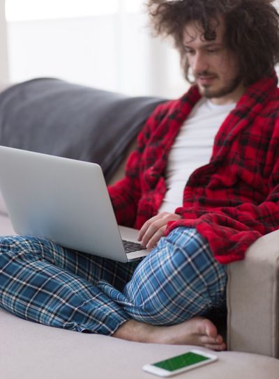 man freelancer in bathrobe working from home