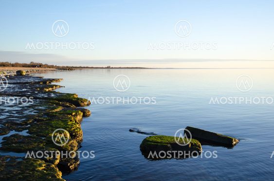 Flat rock coast with calm water