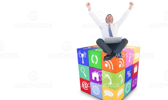 Composite image of excited cheering businessman sitting using his laptop