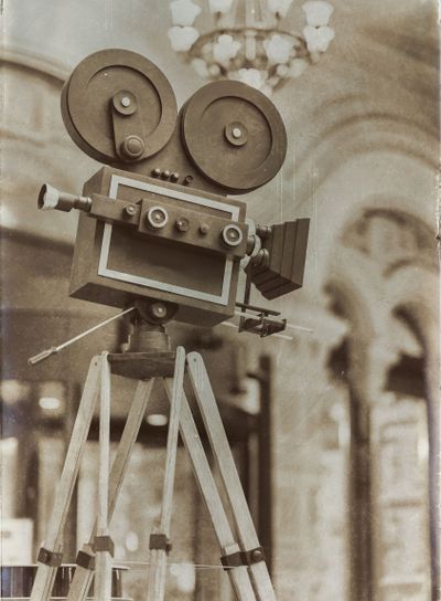 Vintage movie camera on a tripod, model. Processed with...
