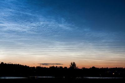 Noctilucent clouds at night sky