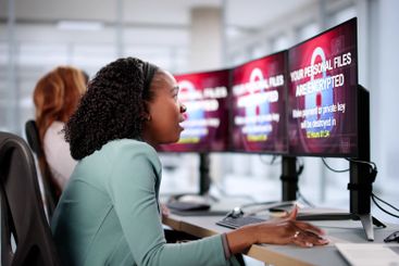 Businesswoman experiencing ransomware extortion attack...