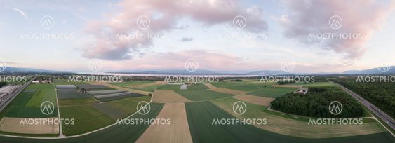panorama of green fields and lake