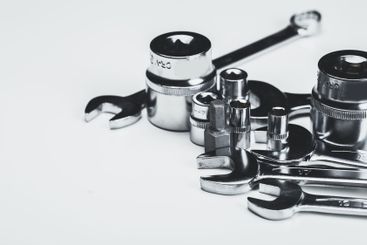 Various metal tools arranged neatly on a light surface...