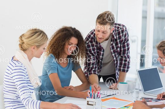 Young happy design team brainstorming together