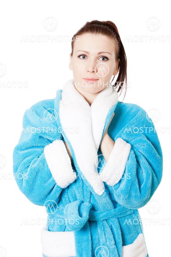 Young attractive woman in sky-blue bathrobe isolated on white