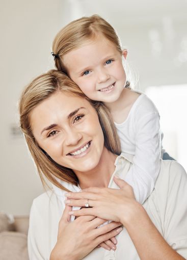 Portrait, girl and woman with hug on sofa for childhood...
